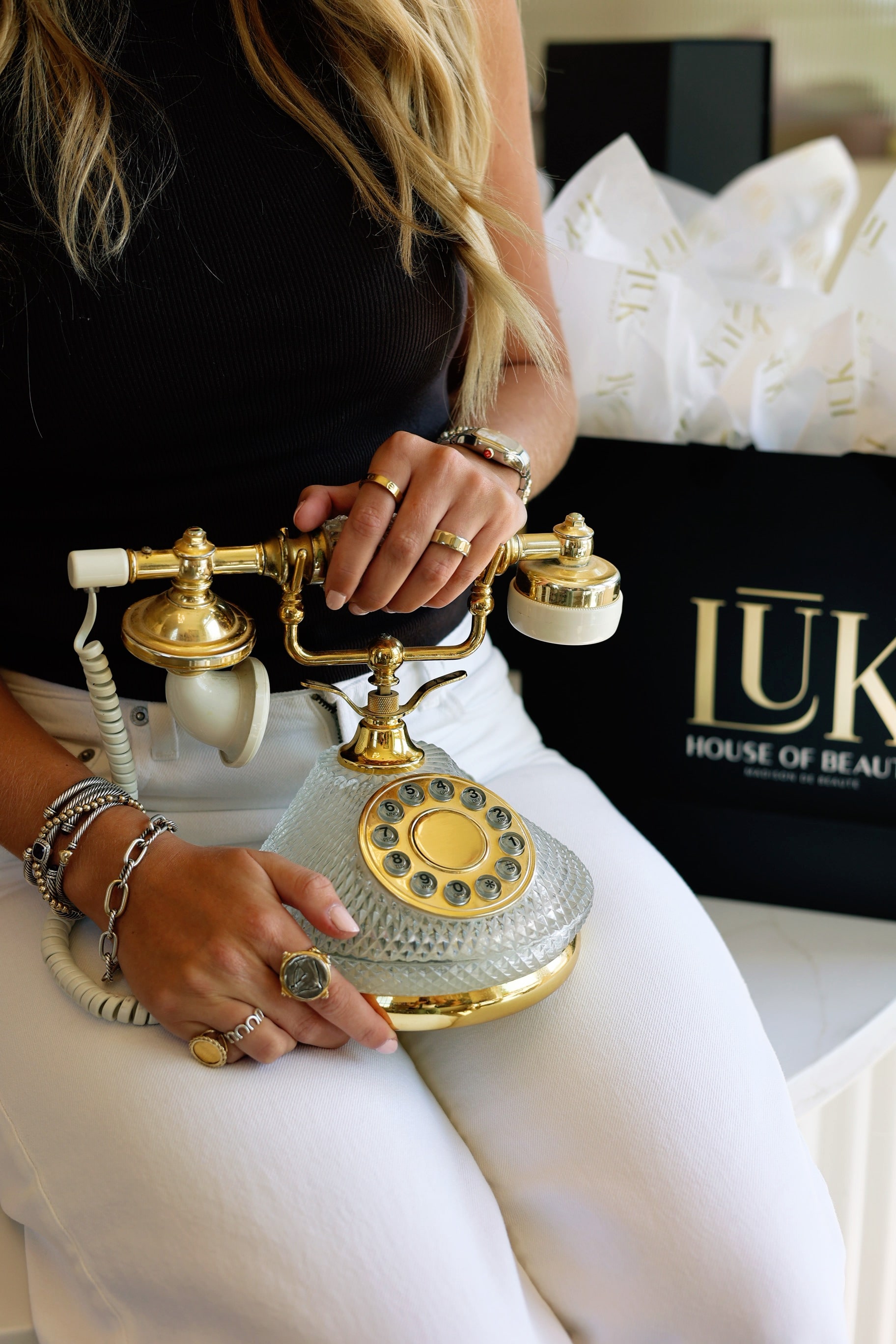 Gold and crystal vintage telephone beside a LŪK House of Beauty gift bag