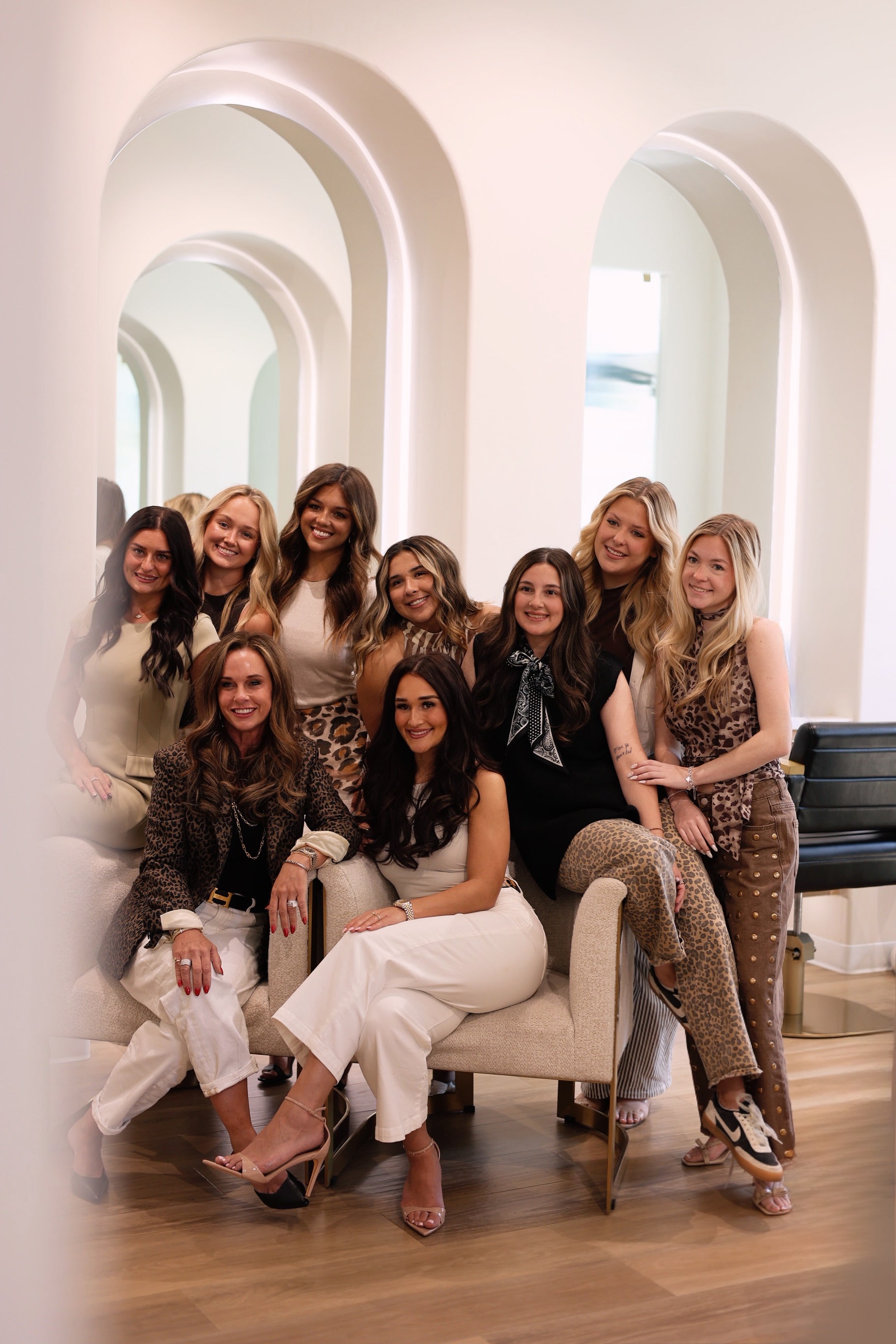 The LŪK House of Beauty team together under the salon's white arches in Norman, Oklahoma