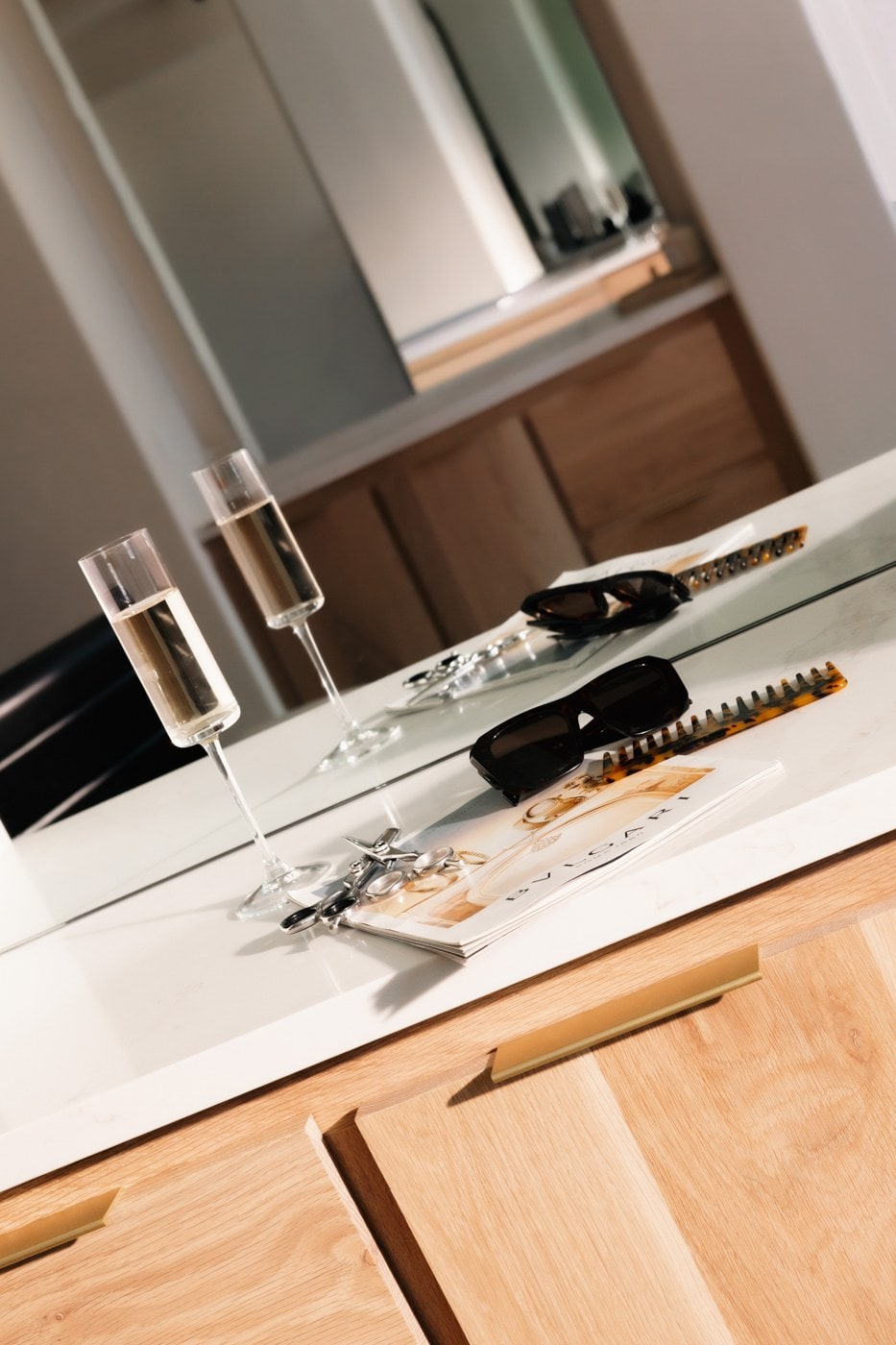 Champagne and jewelry laid out on the counter for complimentary cleaning