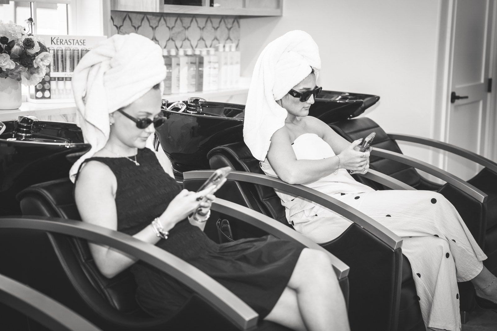 Guests in massage chairs at the LŪK wash basin — the experience