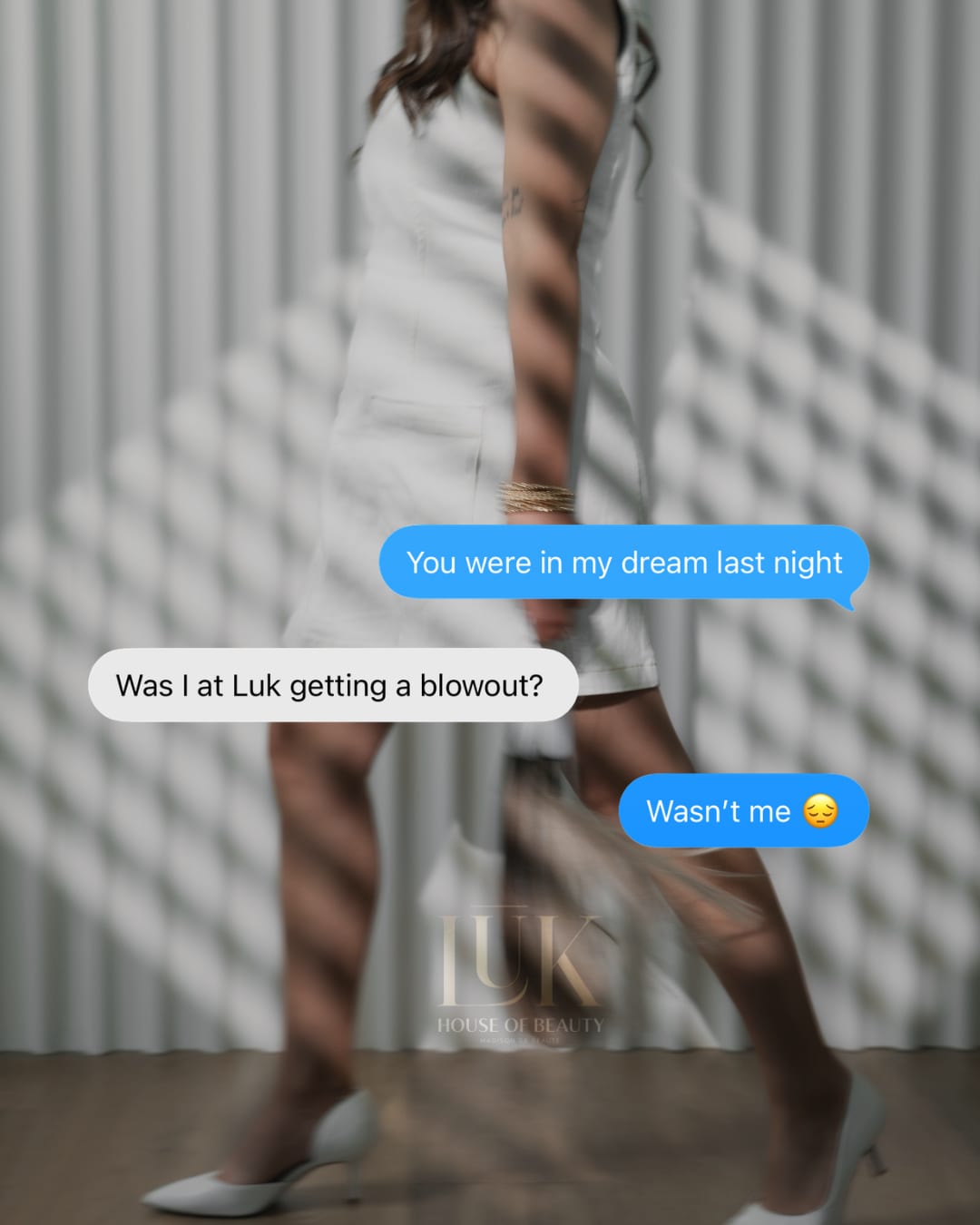 Text conversation over a photo of legs in the striped window light — 'Was I at LŪK getting a blowout?'