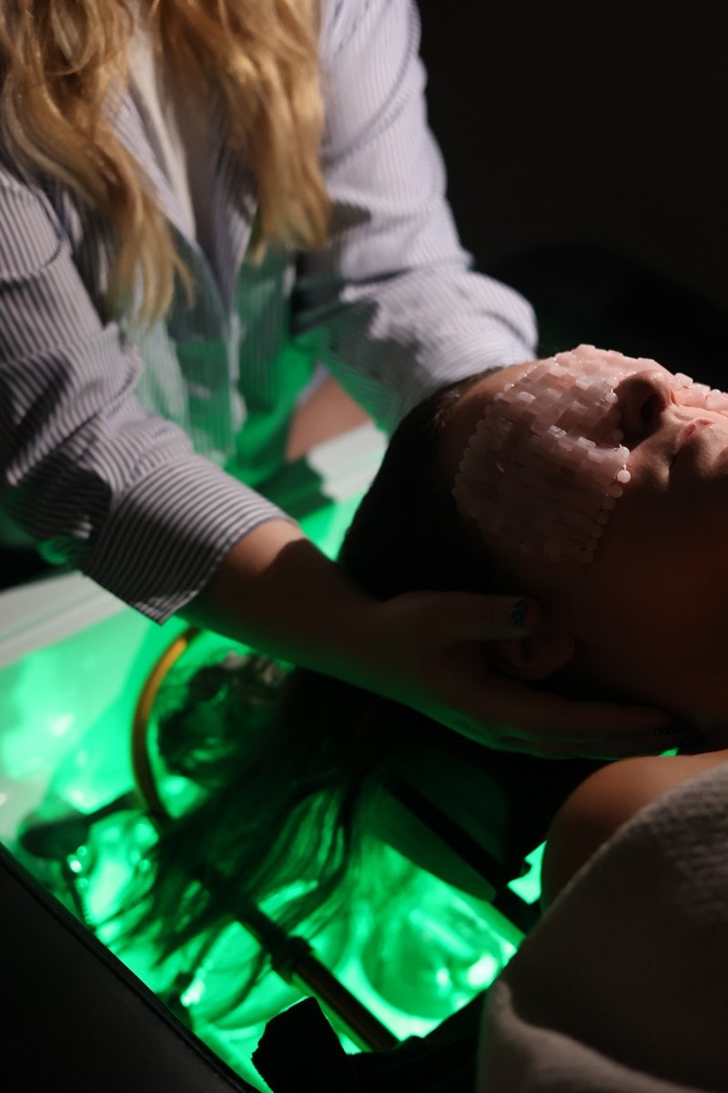 The head spa room under green light at LŪK House of Beauty