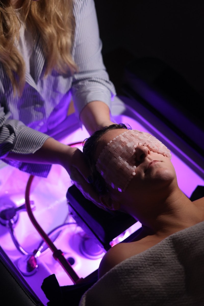 The head spa room under violet light at LŪK House of Beauty